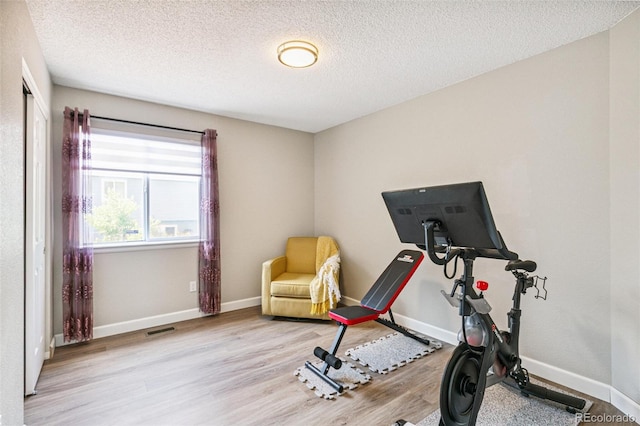 3612 Rosewalk Cir, Highlands Ranch, CO 80129 - workout area with wood finished floors and a textured ceiling