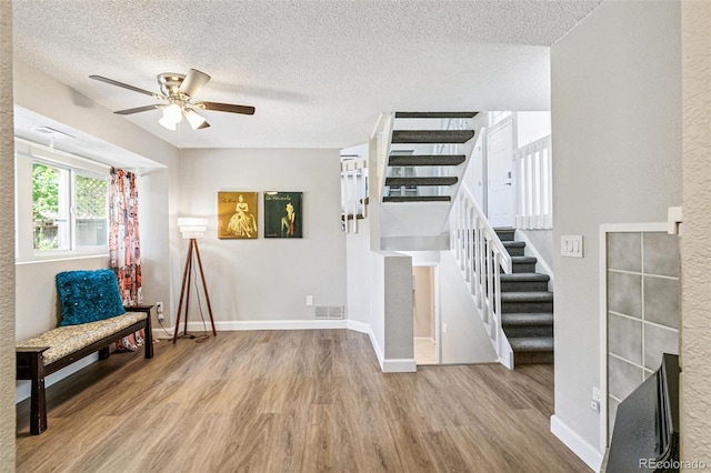 3612 Rosewalk Cir, Highlands Ranch, CO 80129 - living area featuring stairs, wood finished floors, a ceiling fan, and a textured ceiling