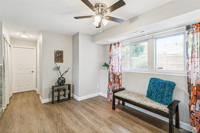 3612 Rosewalk Cir, Highlands Ranch, CO 80129 - living area with light wood-style floors, a textured ceiling, and a ceiling fan