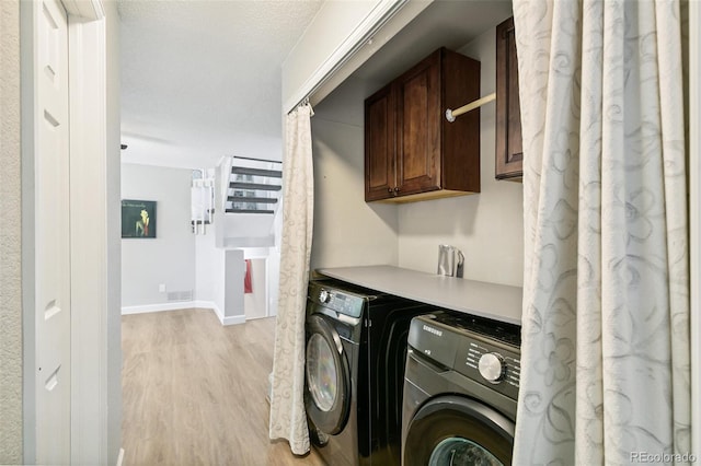 3612 Rosewalk Cir, Highlands Ranch, CO 80129 - laundry room with light wood-style flooring, independent washer and dryer, and cabinet space