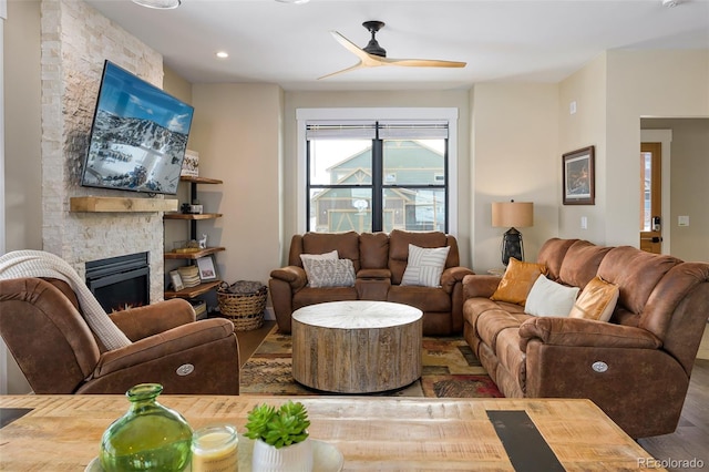 living area featuring ceiling fan, a fireplace, wood finished floors, and recessed lighting