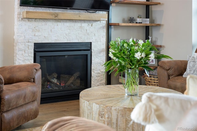 living area with a fireplace and wood finished floors