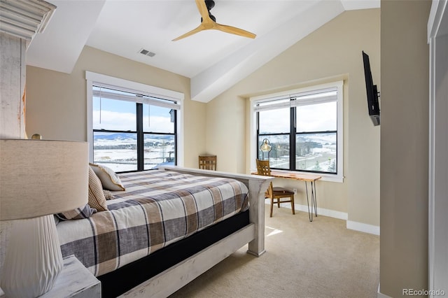 bedroom featuring lofted ceiling, visible vents, light carpet, and multiple windows