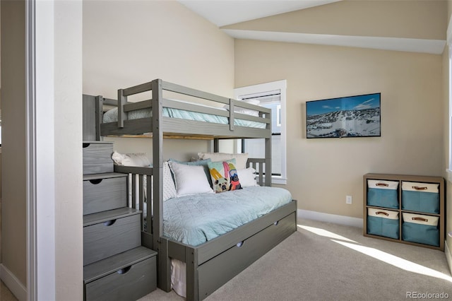 bedroom featuring lofted ceiling, carpet, and baseboards