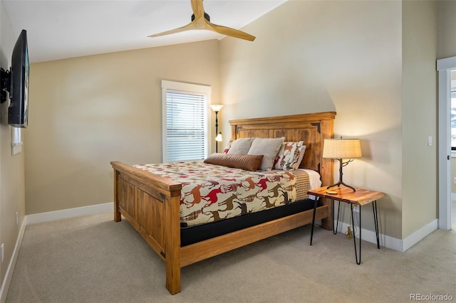 bedroom featuring lofted ceiling, baseboards, and light colored carpet