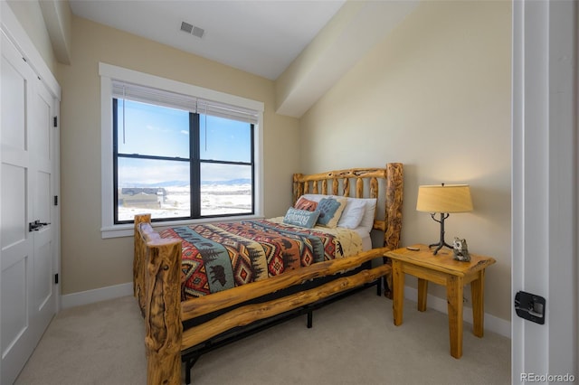 bedroom with light carpet, visible vents, and baseboards