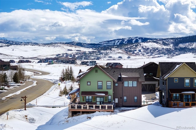 snowy aerial view with a mountain view