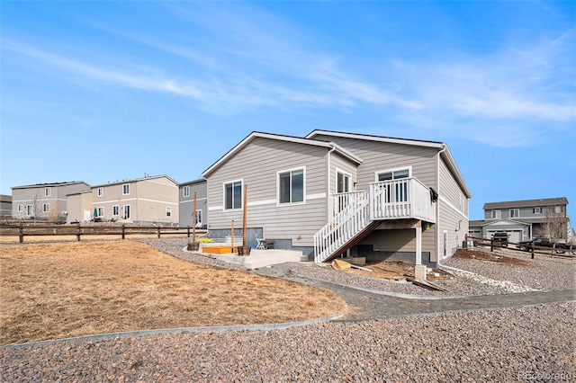 manufactured / mobile home with a wooden deck and a patio