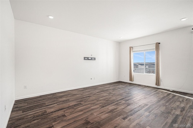 unfurnished room featuring dark wood-type flooring