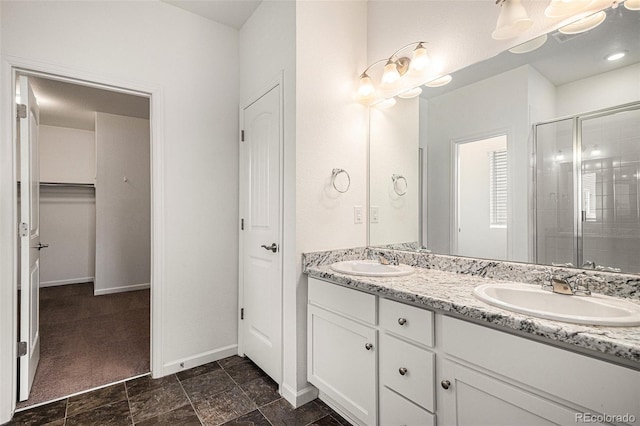 bathroom with vanity and a shower with shower door