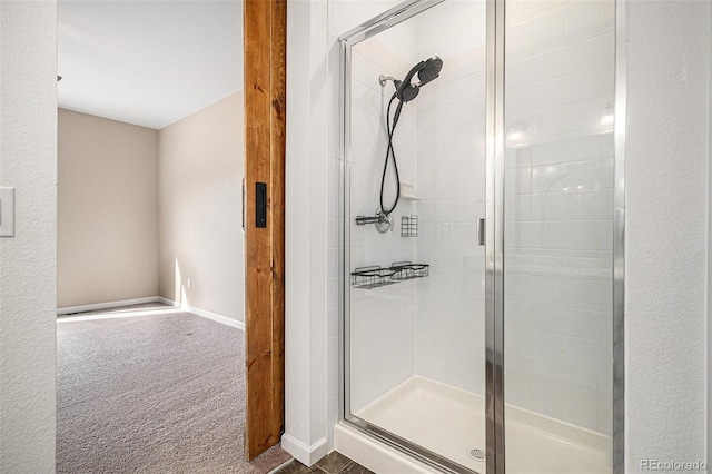 bathroom featuring a shower with shower door