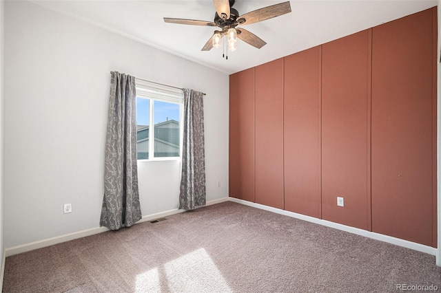 spare room featuring carpet flooring and ceiling fan