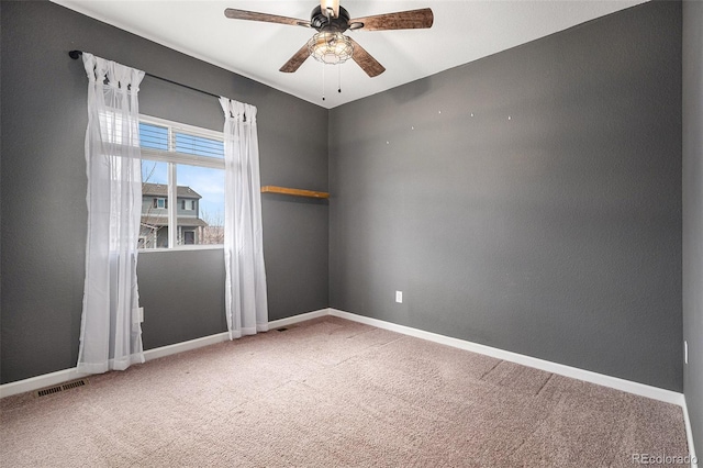 unfurnished room featuring ceiling fan and carpet flooring