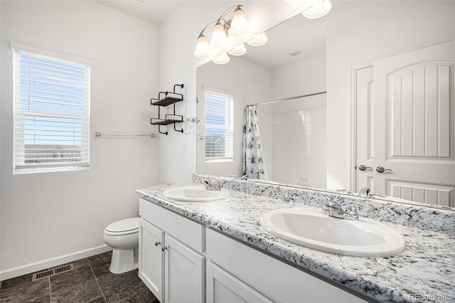 bathroom featuring vanity, toilet, and a shower with shower curtain