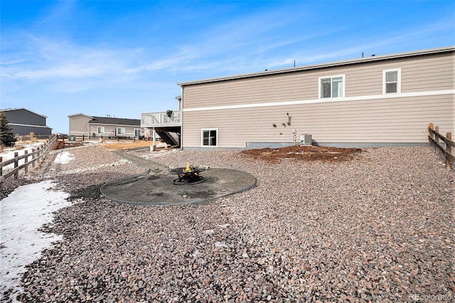 rear view of house featuring central AC unit and a deck