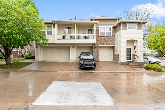 12973 Grant Cir E Unit A, Thornton, CO 80241 - view of front facade with an attached garage, concrete driveway, and a balcony