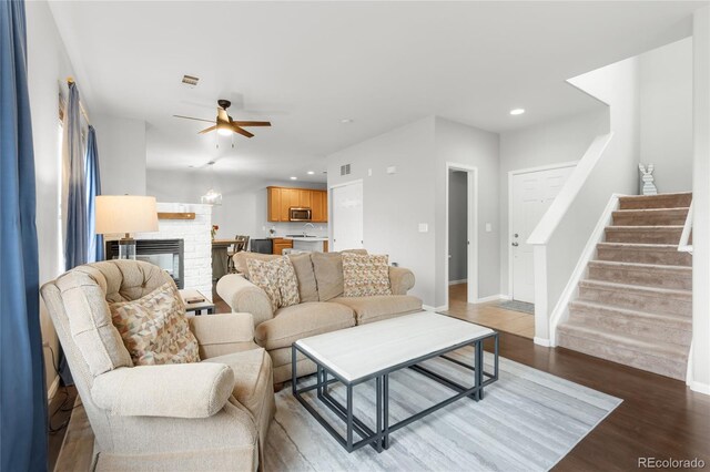 12973 Grant Cir E Unit A, Thornton, CO 80241 - living area featuring wood finished floors, stairs, recessed lighting, ceiling fan, and baseboards