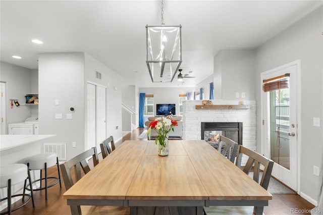 12973 Grant Cir E Unit A, Thornton, CO 80241 - dining room featuring independent washer and dryer, wood finished floors, a fireplace, ceiling fan, and recessed lighting
