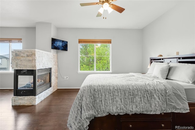 12973 Grant Cir E Unit A, Thornton, CO 80241 - bedroom featuring wood finished floors, a fireplace, baseboards, and ceiling fan