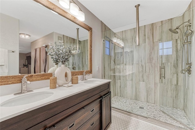 bathroom with a stall shower, tile patterned flooring, a sink, and double vanity