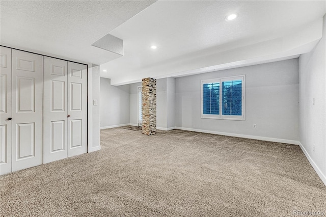 unfurnished bedroom with a textured ceiling, baseboards, carpet flooring, and recessed lighting