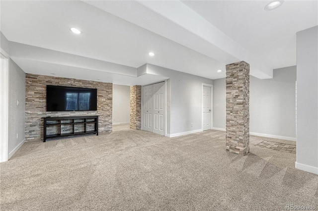 unfurnished living room with recessed lighting, carpet flooring, decorative columns, and baseboards