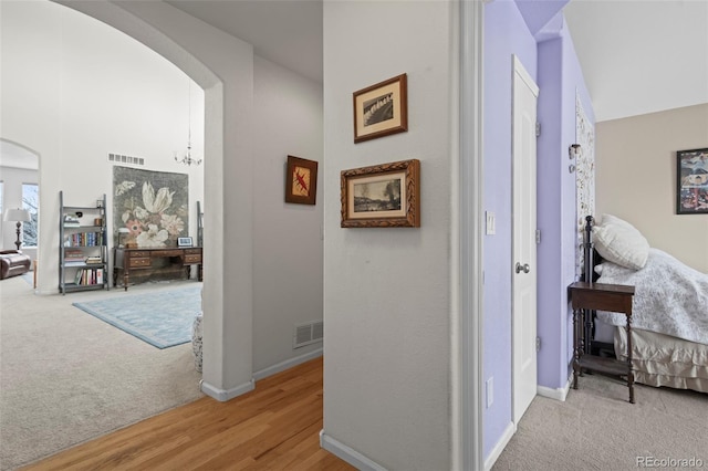 hallway featuring light colored carpet