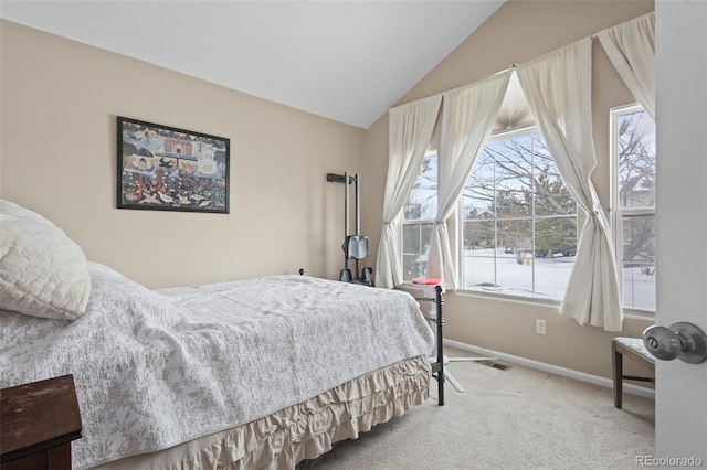 bedroom featuring multiple windows, vaulted ceiling, and carpet