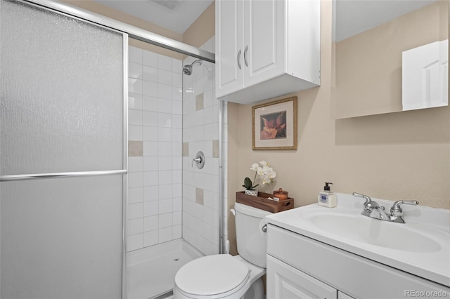 bathroom featuring toilet, walk in shower, and vanity