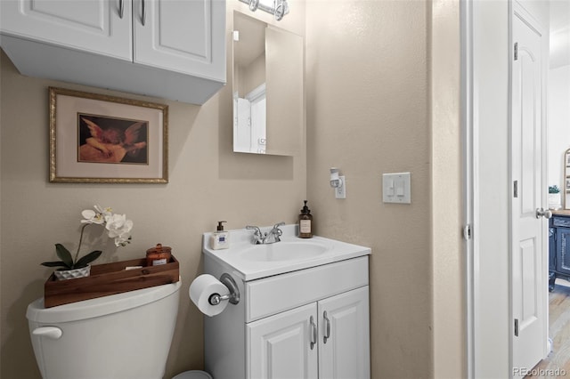 bathroom with toilet and vanity