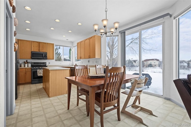 dining space featuring a chandelier and a healthy amount of sunlight