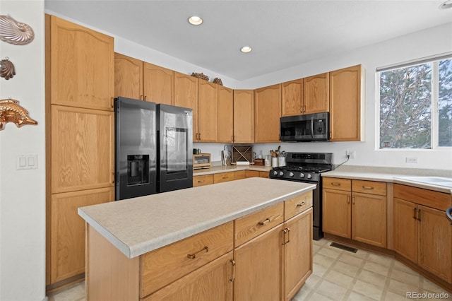 kitchen with black appliances and a kitchen island