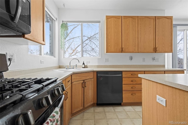 kitchen featuring sink, gas range oven, and black dishwasher