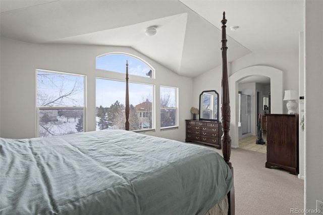 bedroom featuring vaulted ceiling and light colored carpet