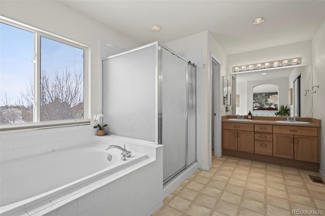 bathroom with plus walk in shower and vanity