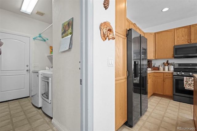 kitchen featuring separate washer and dryer and appliances with stainless steel finishes