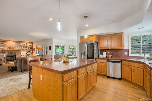 2359 Indian Paintbrush Cir, Highlands Ranch, CO 80129 - kitchen featuring appliances with stainless steel finishes, a sink, light wood finished floors, plenty of natural light, and recessed lighting