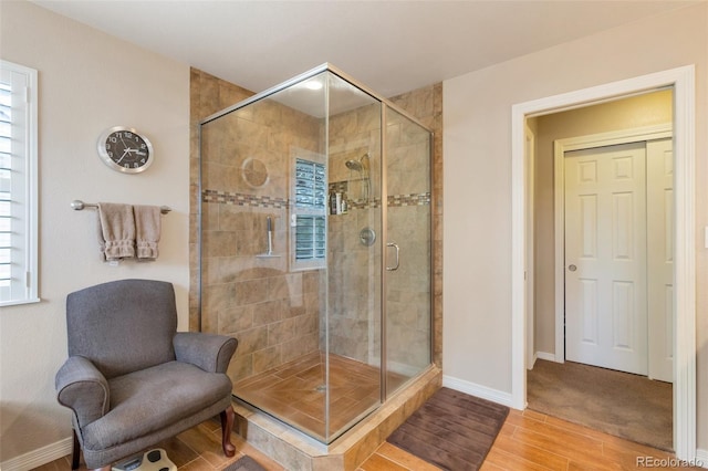 2359 Indian Paintbrush Cir, Highlands Ranch, CO 80129 - bathroom featuring wood finished floors, baseboards, and a shower stall