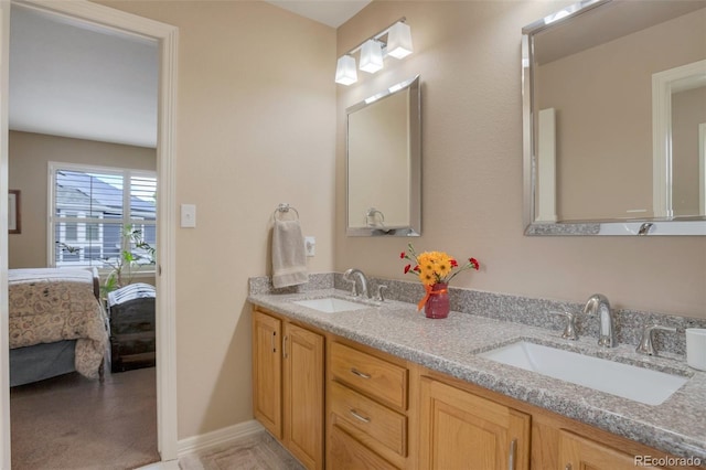 2359 Indian Paintbrush Cir, Highlands Ranch, CO 80129 - full bath with double vanity, connected bathroom, and baseboards