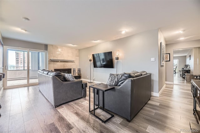 130 N Pearl St Unit 1001, Denver, CO 80203 - living room with recessed lighting, baseboards, a tile fireplace, and light wood-style floors