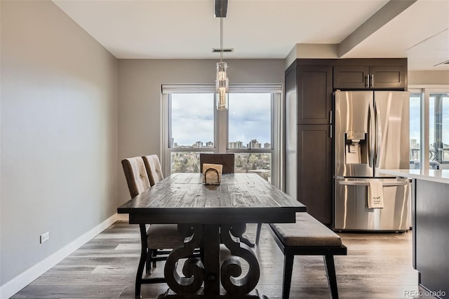 130 N Pearl St Unit 1001, Denver, CO 80203 - dining room with visible vents, baseboards, and light wood finished floors