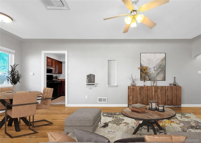 828 Mariposa St, Denver, CO 80204 - living room featuring light wood-type flooring, baseboards, and a ceiling fan