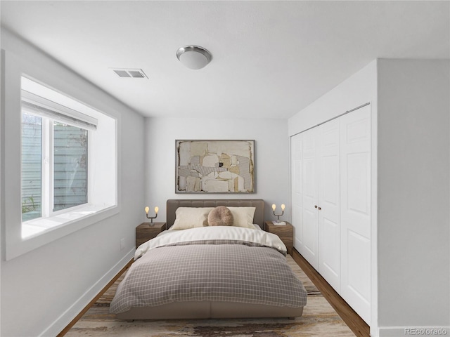 828 Mariposa St, Denver, CO 80204 - bedroom featuring wood finished floors, a closet, and baseboards