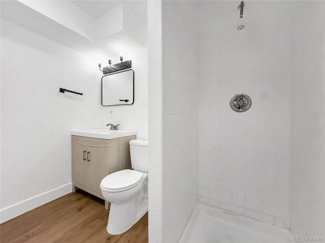 828 Mariposa St, Denver, CO 80204 - bathroom featuring toilet, wood finished floors, tiled shower, and vanity