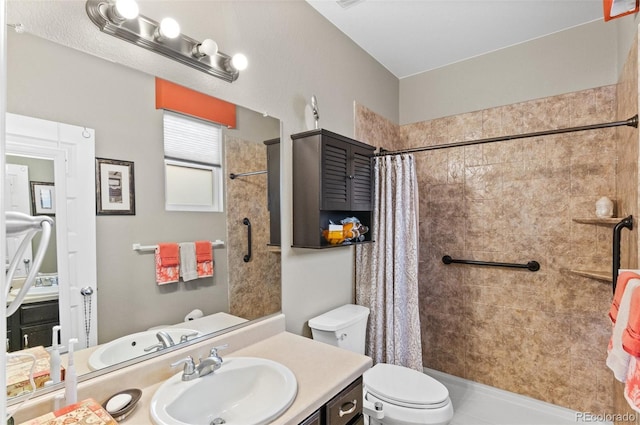 bathroom with toilet, vanity, and a shower with curtain