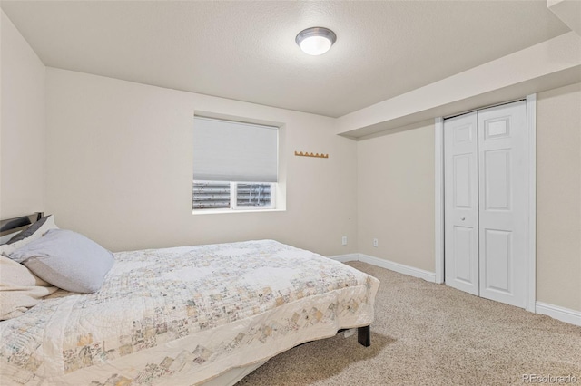 bedroom featuring a closet, carpet floors, and a textured ceiling