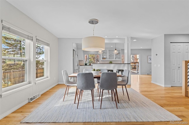 dining space featuring light wood-type flooring