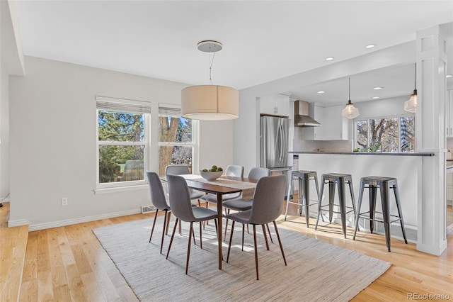 dining area with light hardwood / wood-style flooring