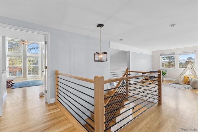 staircase featuring a notable chandelier and wood-type flooring