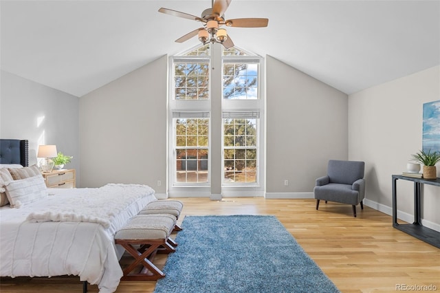 bedroom with vaulted ceiling, ceiling fan, and light wood-type flooring